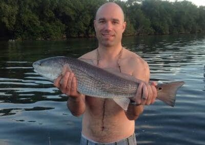 man holding a fish caught on a Seein Red Sportfishing Charter