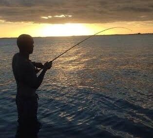 man fishing at sunset