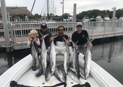 2 men holding the 6 fish they caught on a Seein Red Sportfishing Charter