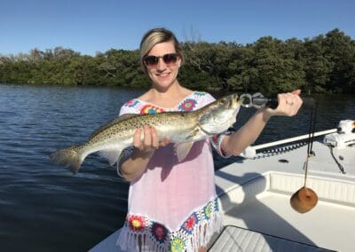 couple holding a fish caught on a Seein Red Sportfishing Charter