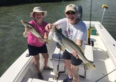 couple holding a fish caught on a Seein Red Sportfishing Charter