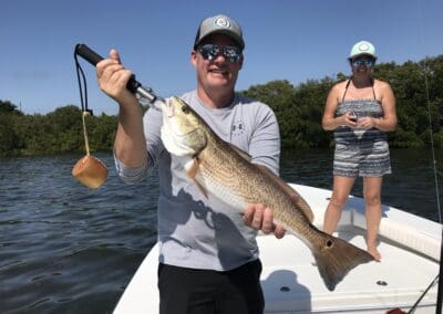 man holding a fish caught on a Seein Red Sportfishing Charter