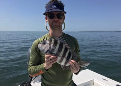 man holding a fish caught on a Seein Red Sportfishing Charter