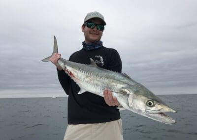 man holding a fish caught on a Seein Red Sportfishing Charter