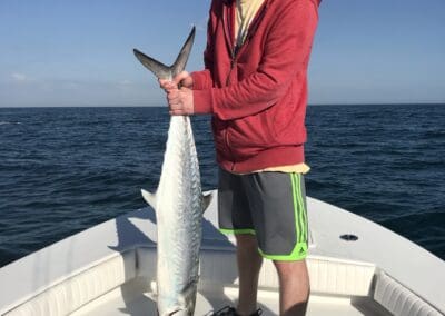 man holding a fish caught on a Seein Red Sportfishing Charter