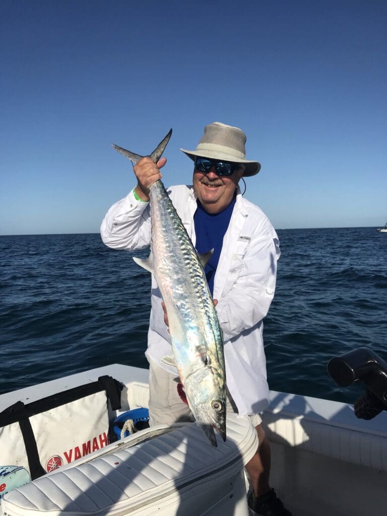 man holding a fish caught on a Seein Red Sportfishing Charter