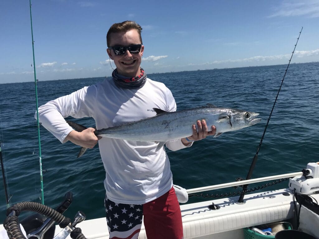 kid holding a fish caught on a Seein Red Sportfishing Charter