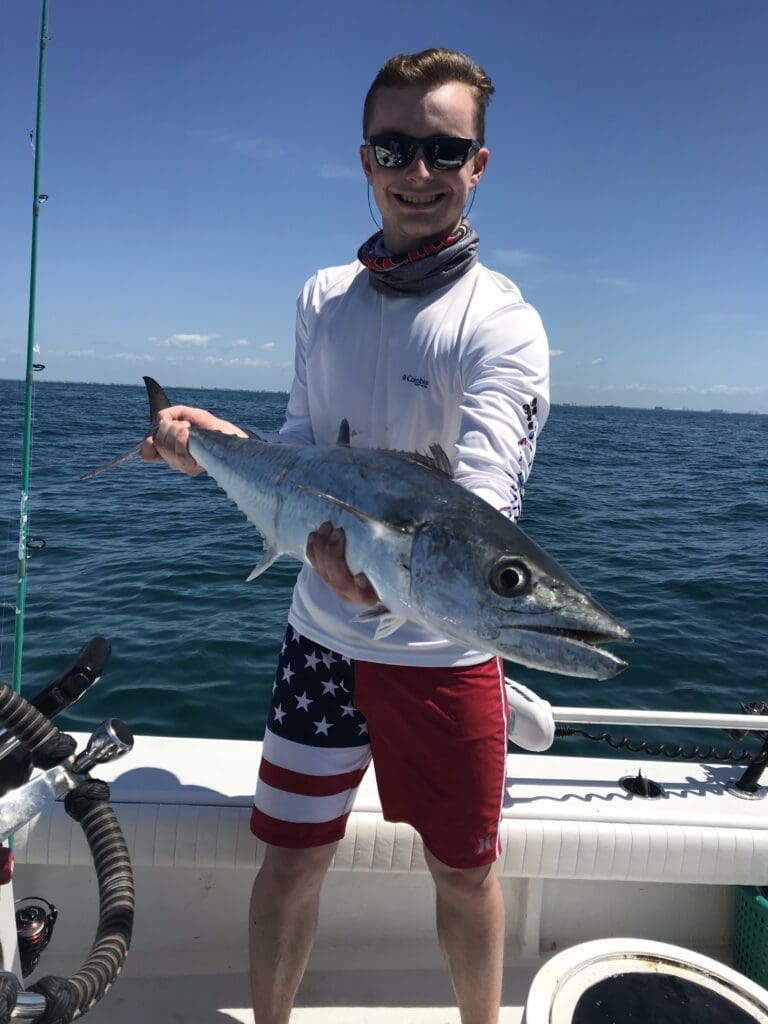 man holding a fish caught on a Seein Red Sportfishing Charter