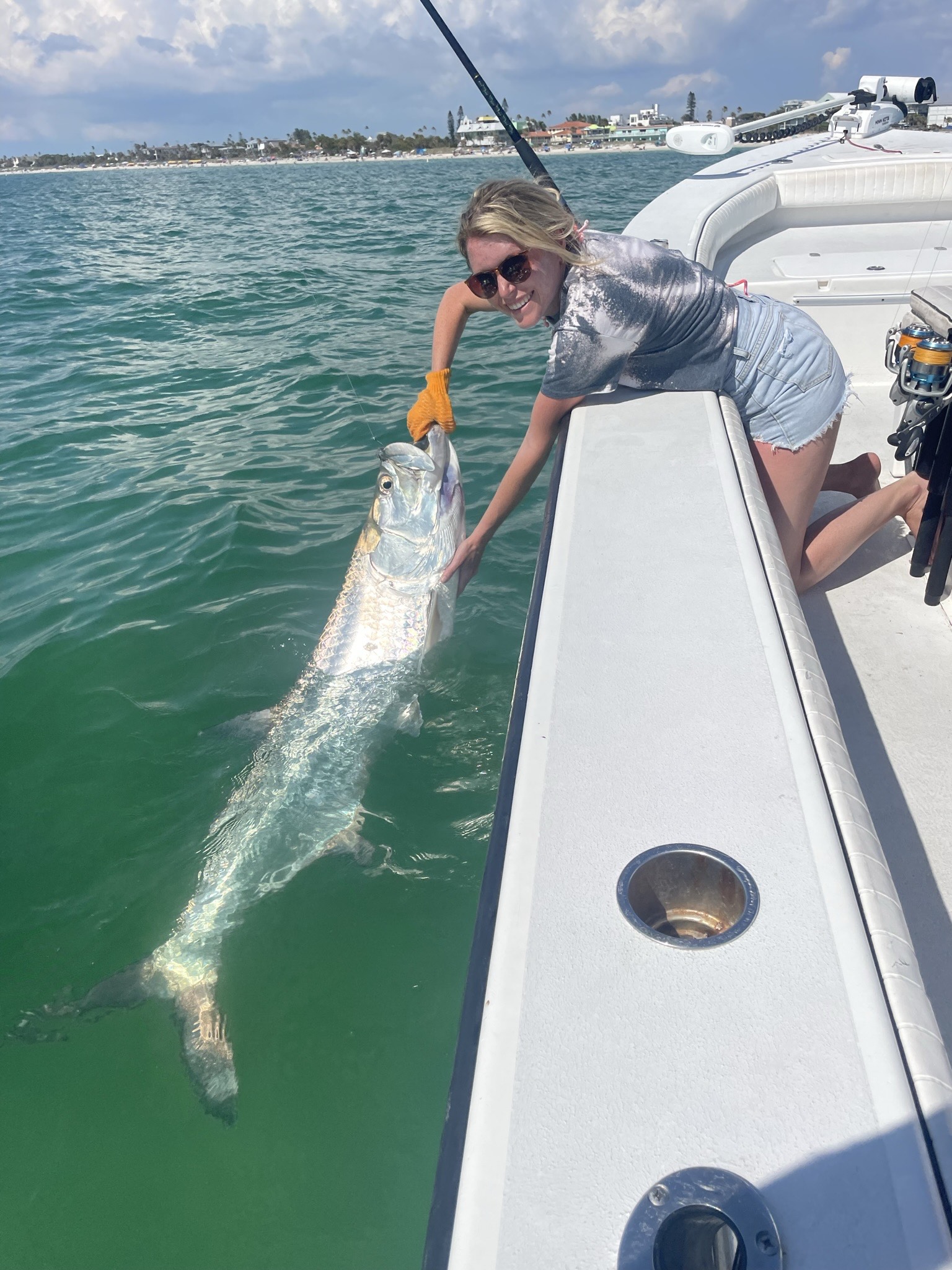 capatin spencer helping a woman bring in a tarpon