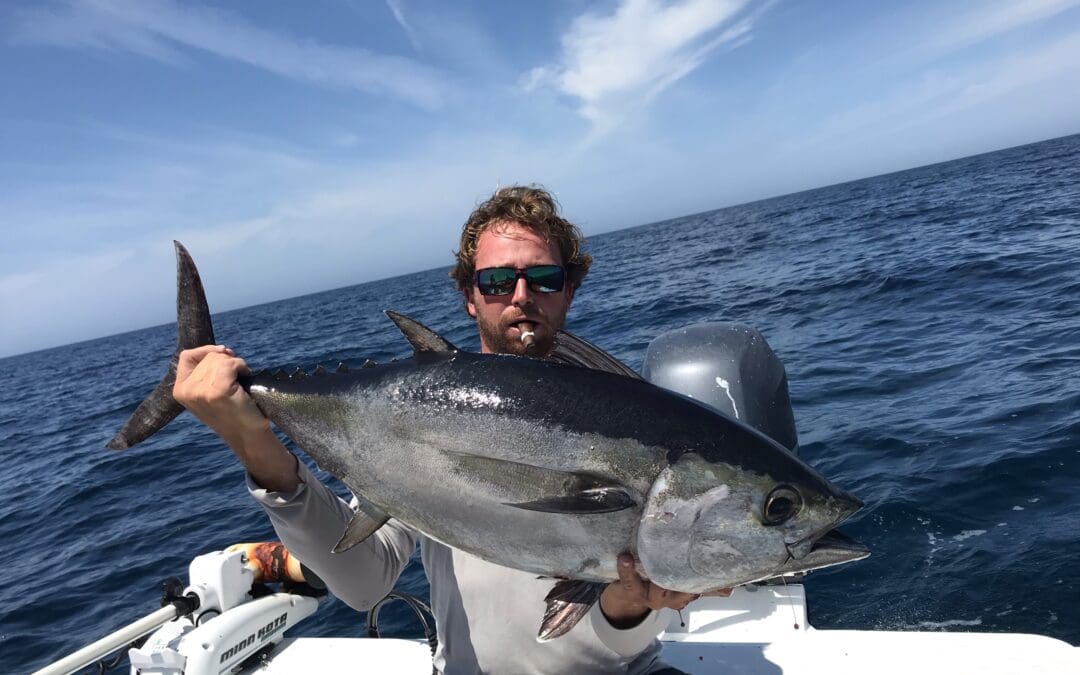 captain spencer holding a fish caught on his charter