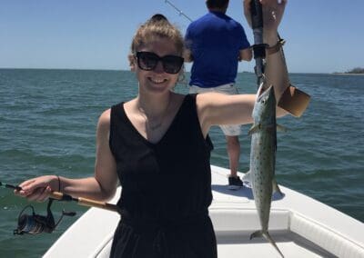 woman holding a fish she caught