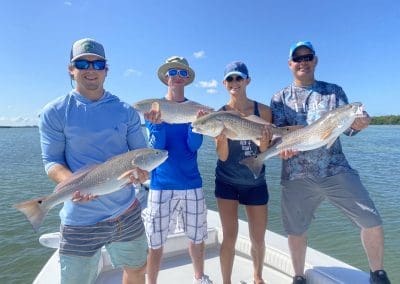 4 people holding their fish