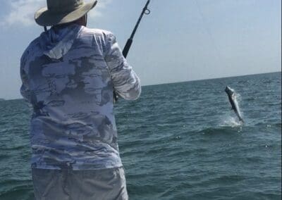 Tarpon fishing with a fighting fish on the line